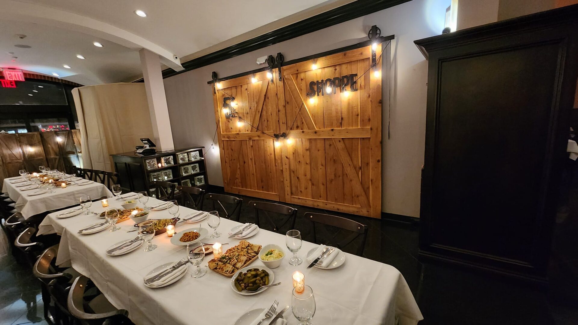 Private Room Event Space 12 A long table with plates and glasses on it