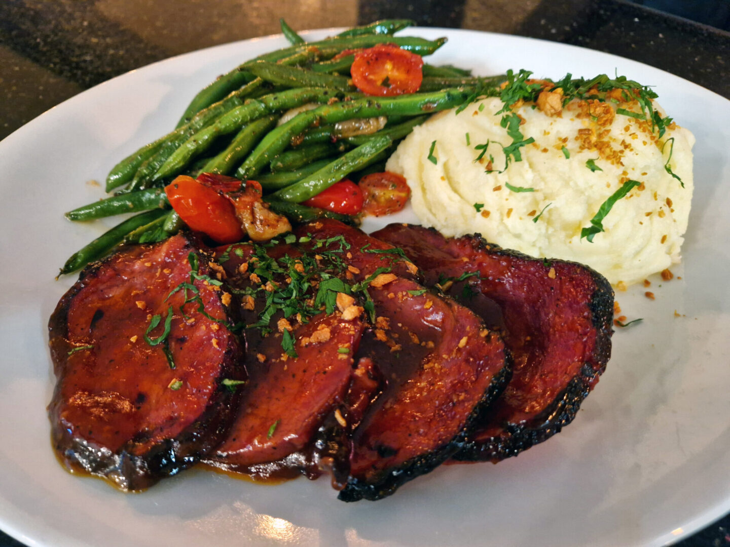 Smoked Brisket in Gravy Meal (1) A plate of food with meat and vegetables on it.