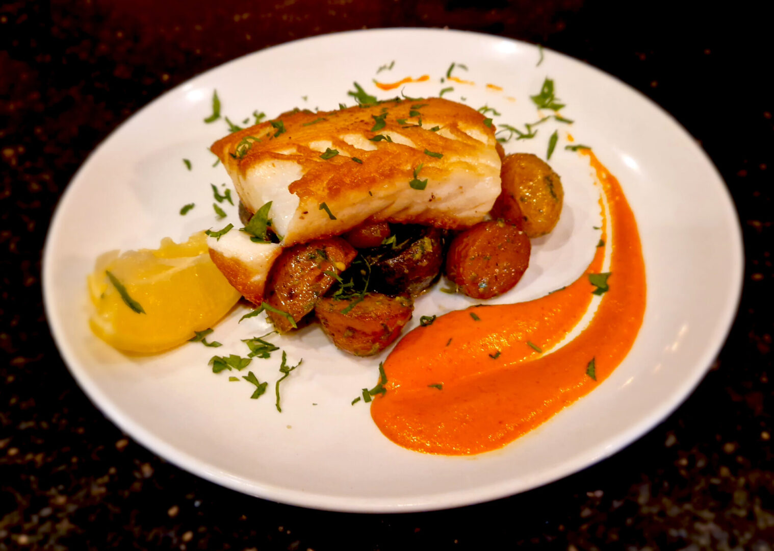 A plate of food with potatoes and sauce on it.